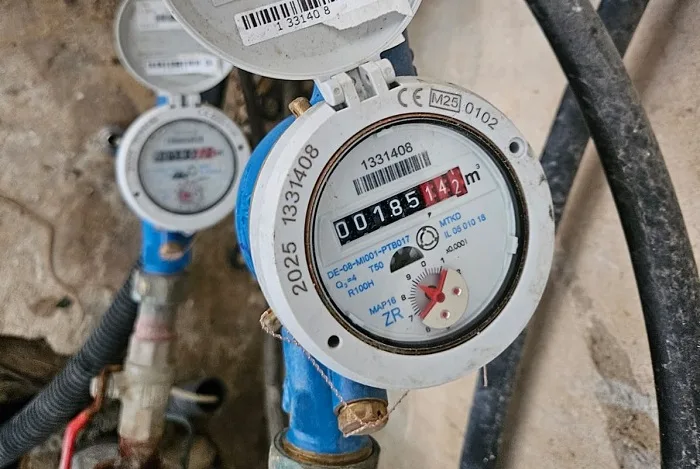 צילום מד מים כשהברזים סגורים במהלך בדיקת מקור נזילה בגינה או בחצר